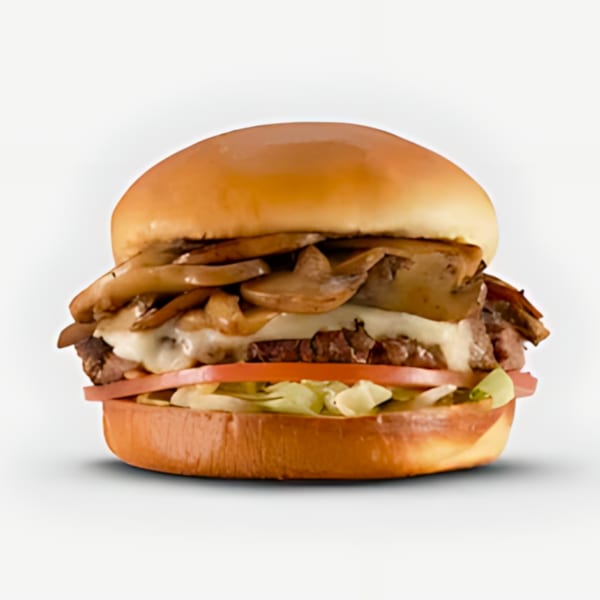 Blazin’ Grill burger with mushrooms, melted cheese, tomatoes, and lettuce on a bun.